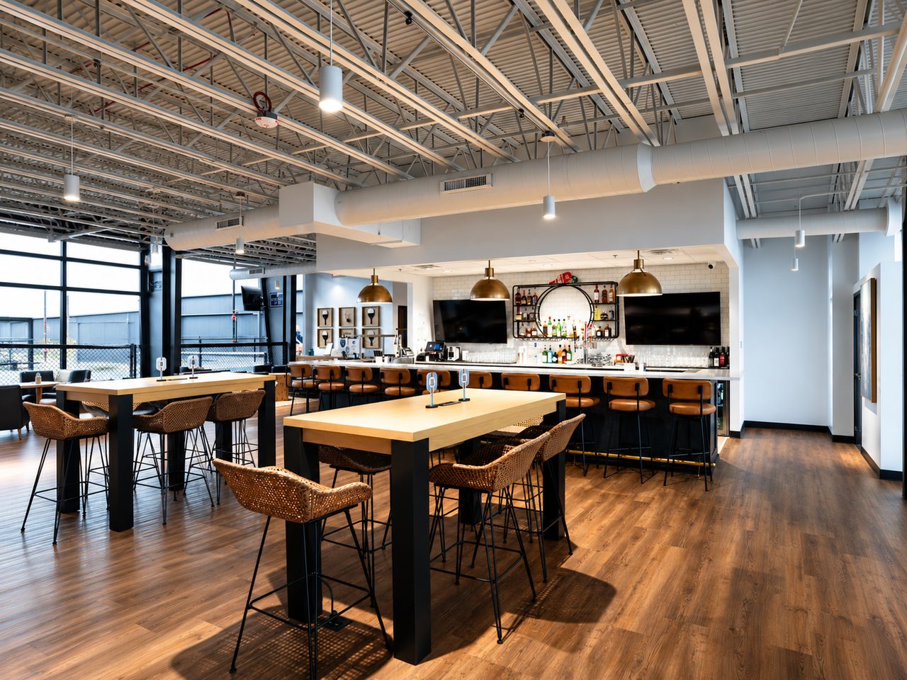 The Greystone Grill bar and high top tables with pendant lights and views over the courts