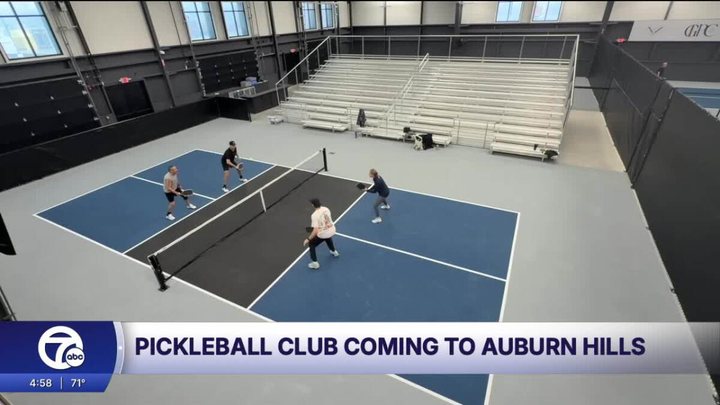 WXYZ video still: players on a Greystone court with the arena bleachers behind them
