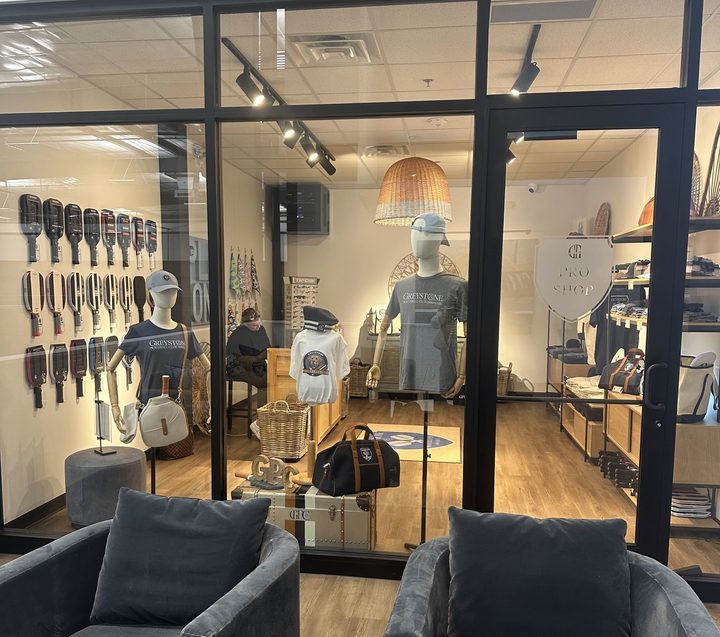 The Greystone Pro Shop window with paddles, apparel and bags on display